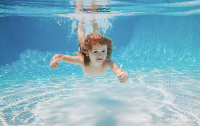 underwater kid swimming pool child swim dive underwater kid with thumbs up pool active lifestyle watersport activity swimming lessons summer vacation with child water