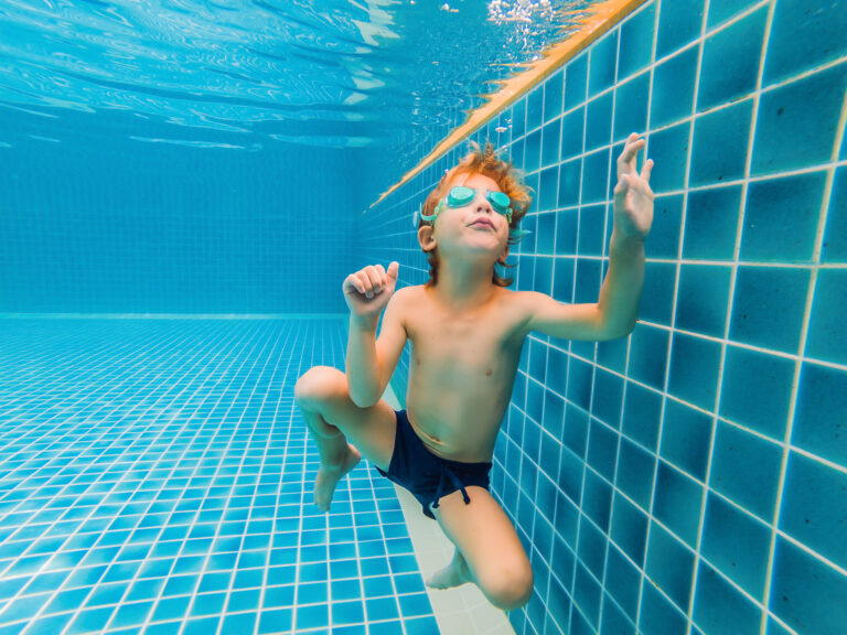 underwater young boy fun swimming pool with goggles summer vacation fun 1